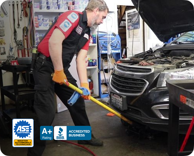 A mechanic working on a vehicle | Armstrong Automotive