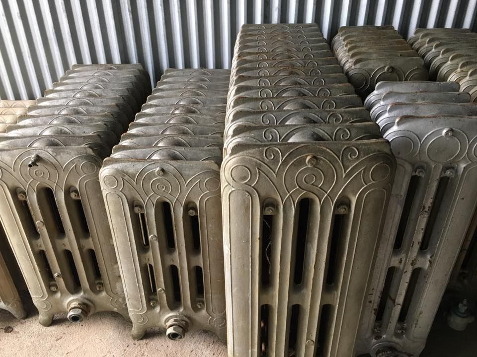 Vintage cast iron radiators prepared for repair or reuse in traditional heating systems