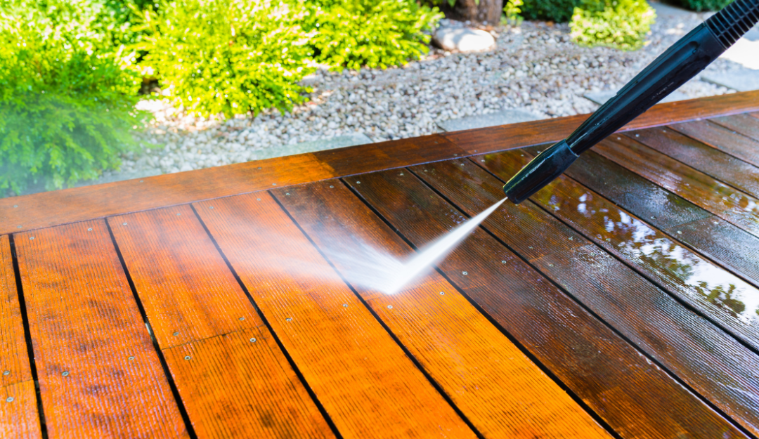 A picture of someone pressure washing a wood deck in Mandeville, LA