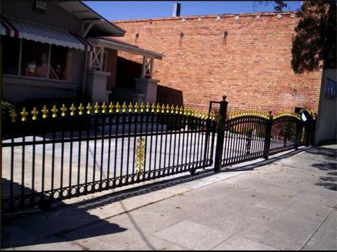 Black Curve Fence With Yellow On Top — Mellman & Perdue CPAs — Oakland, CA