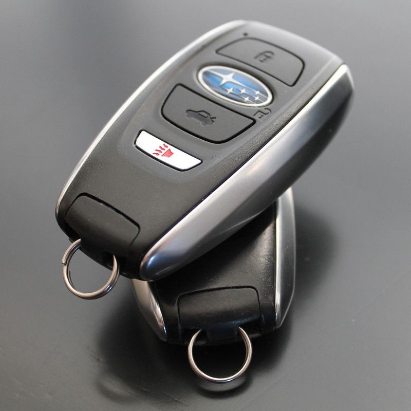 Man using lockpicker to unlock a red car door.