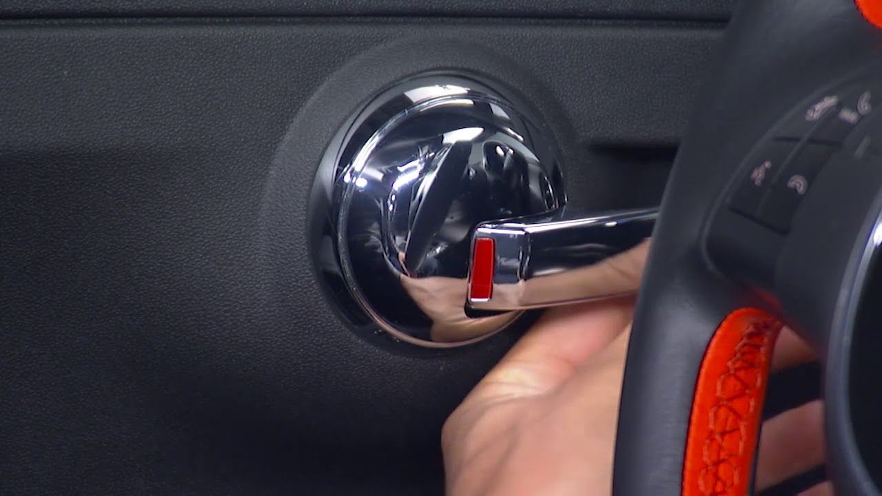 Locksmith attempting to unlock a car door using a lockpicker tool.