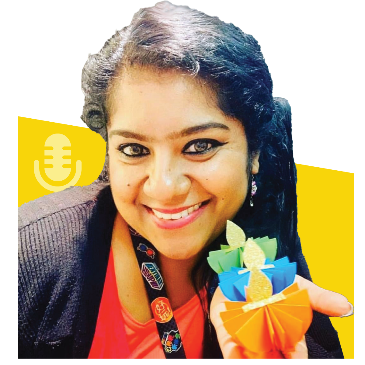 Woman with dark hair holding colorful paper lamps, smiling, and looking at the camera.