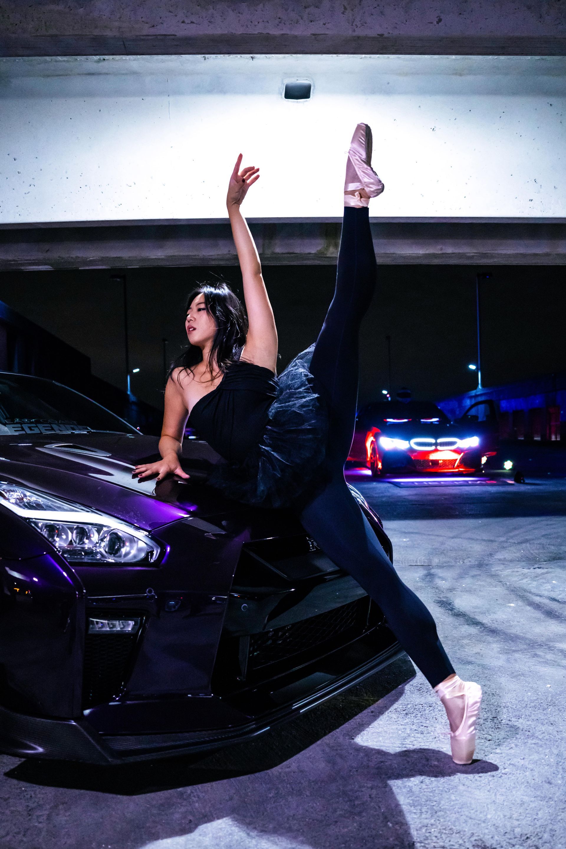 Model Minnie Lee performing ballet on pointe beside a Nissan GTR at the Checkm8 private car meet, photographed by Josanna Uy in NYC.
