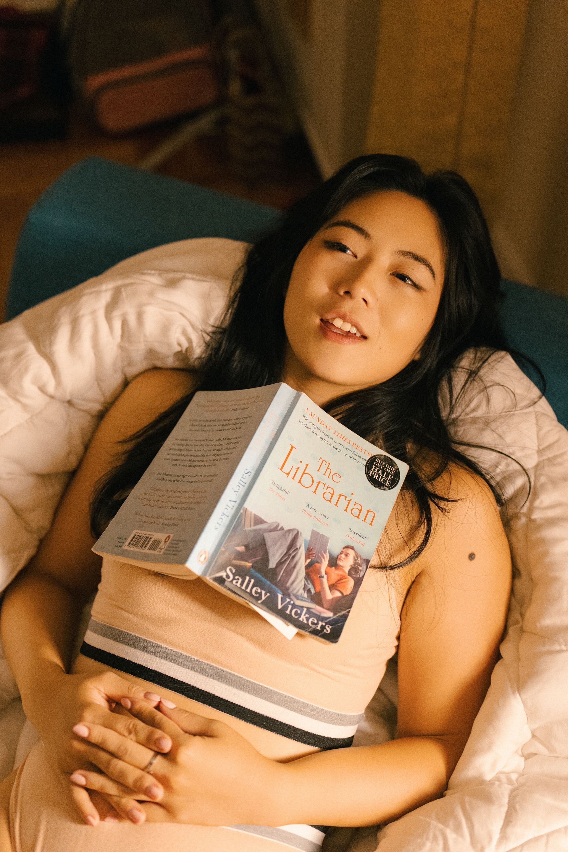 Minnie Lee lifestyle model relaxing with a book at home — cozy editorial portrait for wellness, loungewear, and lifestyle brand campaigns.