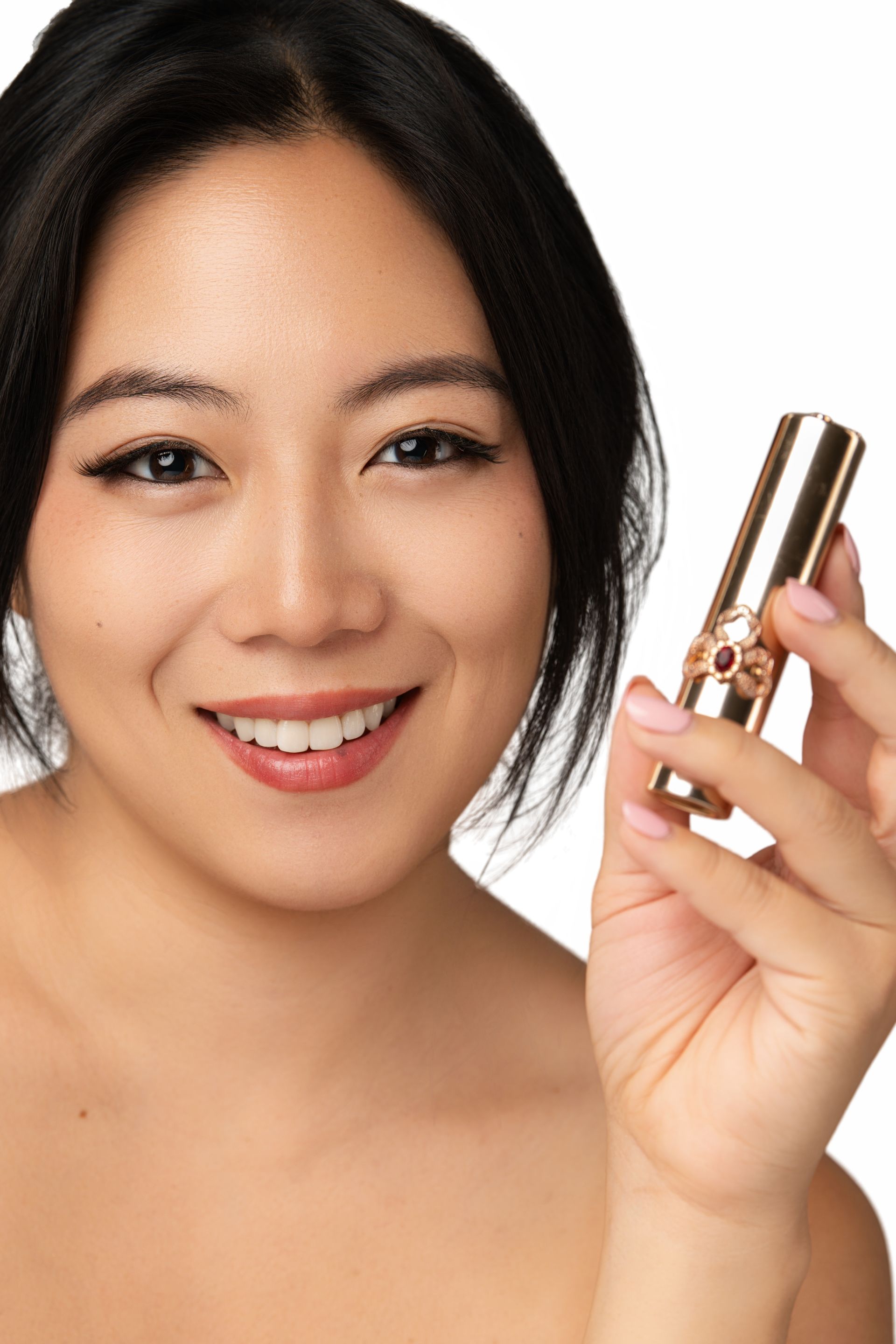 Beauty portrait of Minnie Lee holding Ohui lipstick — NYC-based model for skincare, makeup, and luxury beauty campaigns.