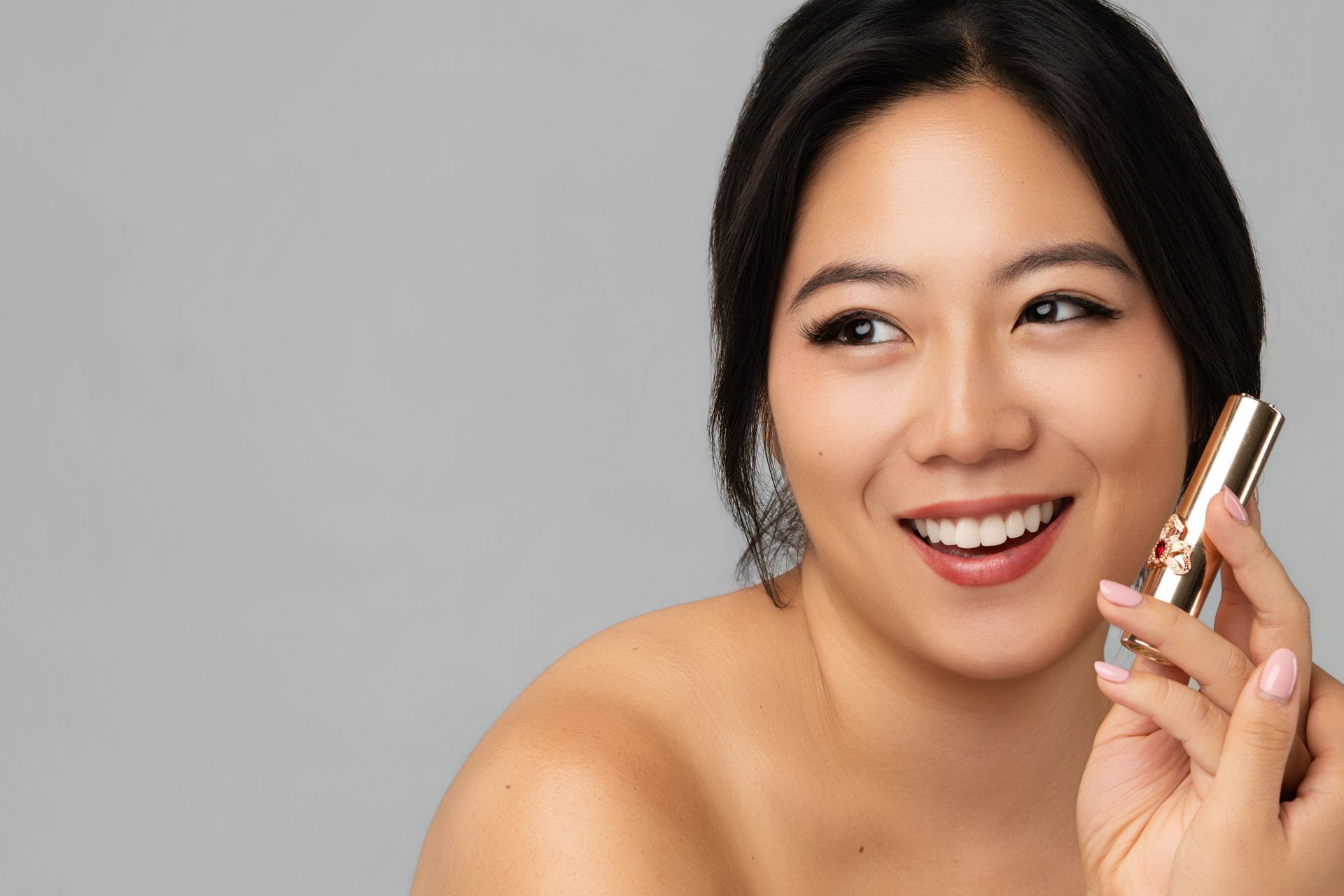 Minnie Lee modeling Ohui luxury lipstick — beauty campaign portrait for Korean skincare and cosmetics brand.