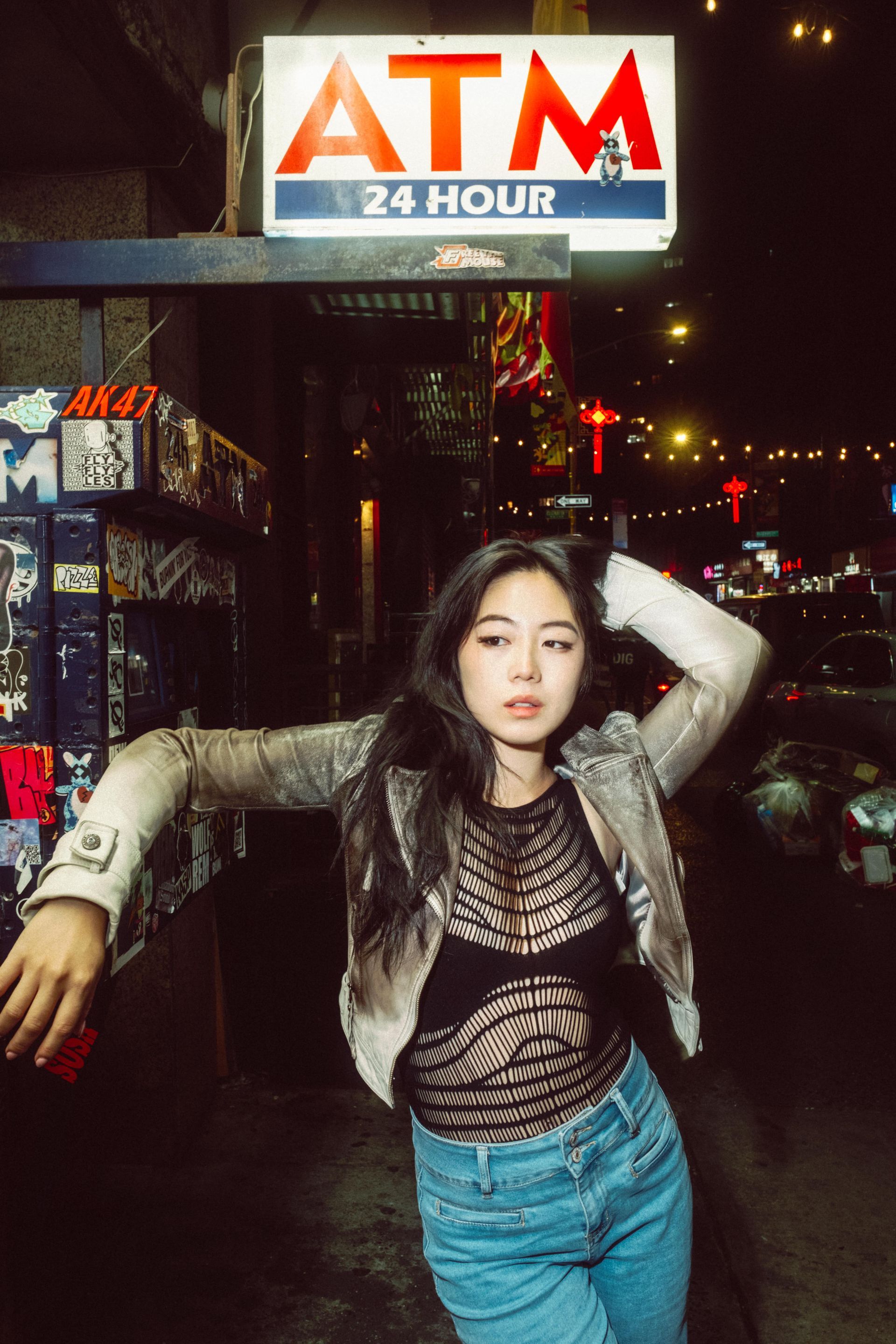 Urban nighttime portrait by Dan Visintainer featuring model Minnie Lee, blending cinematic lighting with expressive editorial photography. Shot in Chinatown NYC