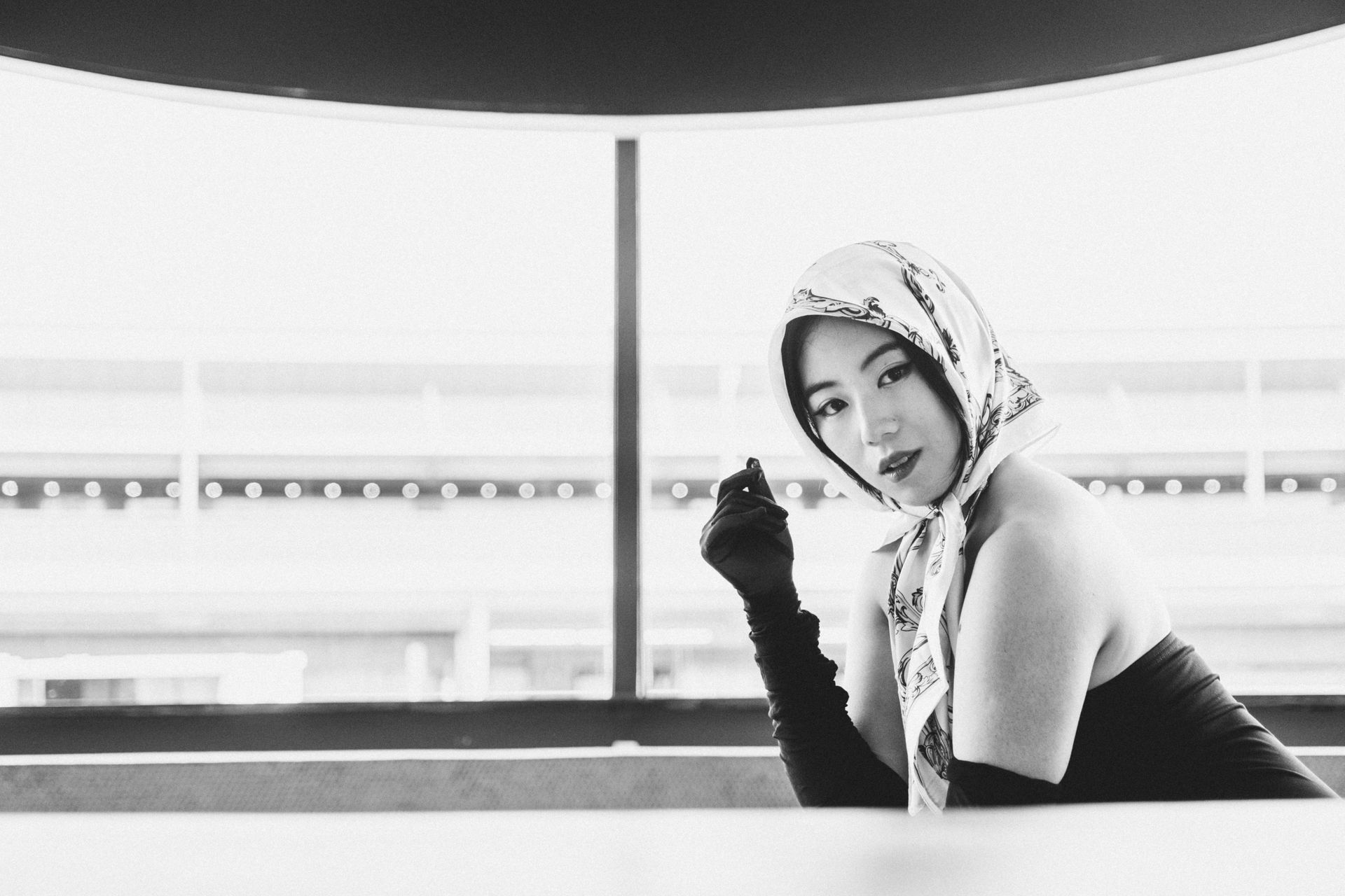 Editorial black and white fashion portrait by Minnie Lee, photographed at the TWA Hotel