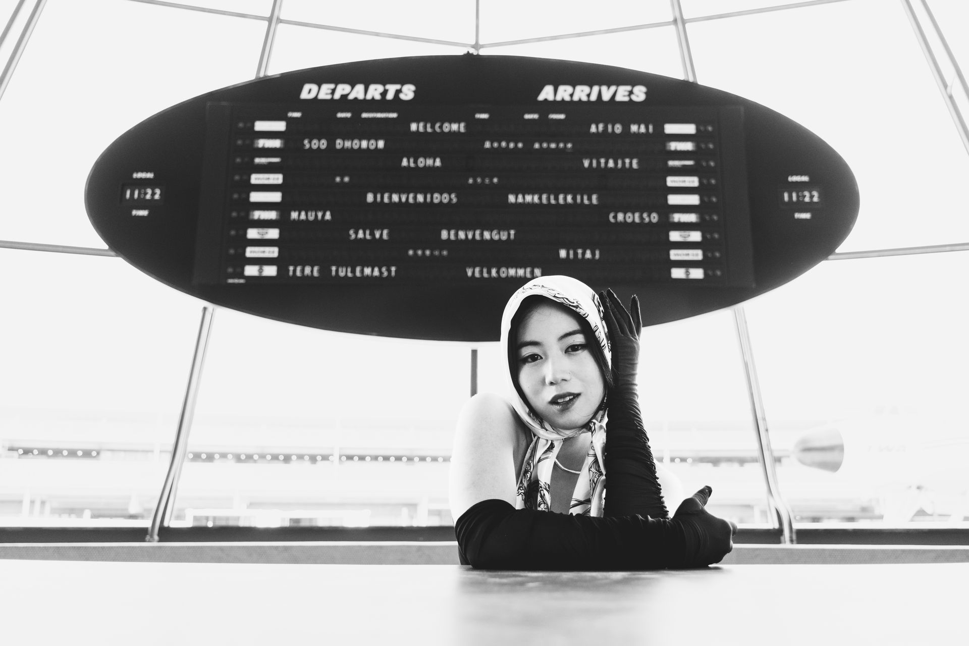Editorial fashion portrait by Minnie Lee, photographed at the TWA Hotel dashboard in black and white