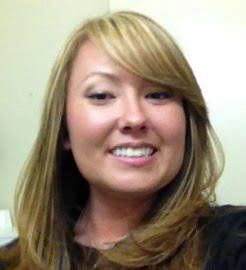 A woman with long blonde hair is smiling for the camera.