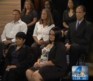 A group of people are sitting in front of a screen with the number 4 on it