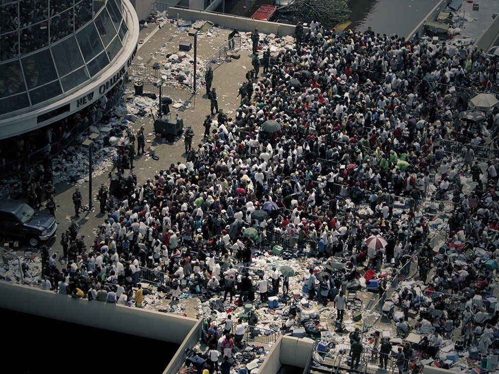 A large crowd of people are gathered outside of a building.
