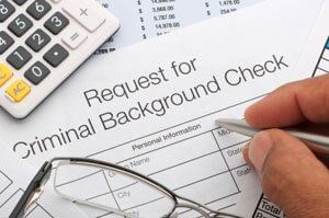 Hand Writing on a Paper — Background Checks in Sacramento, CA