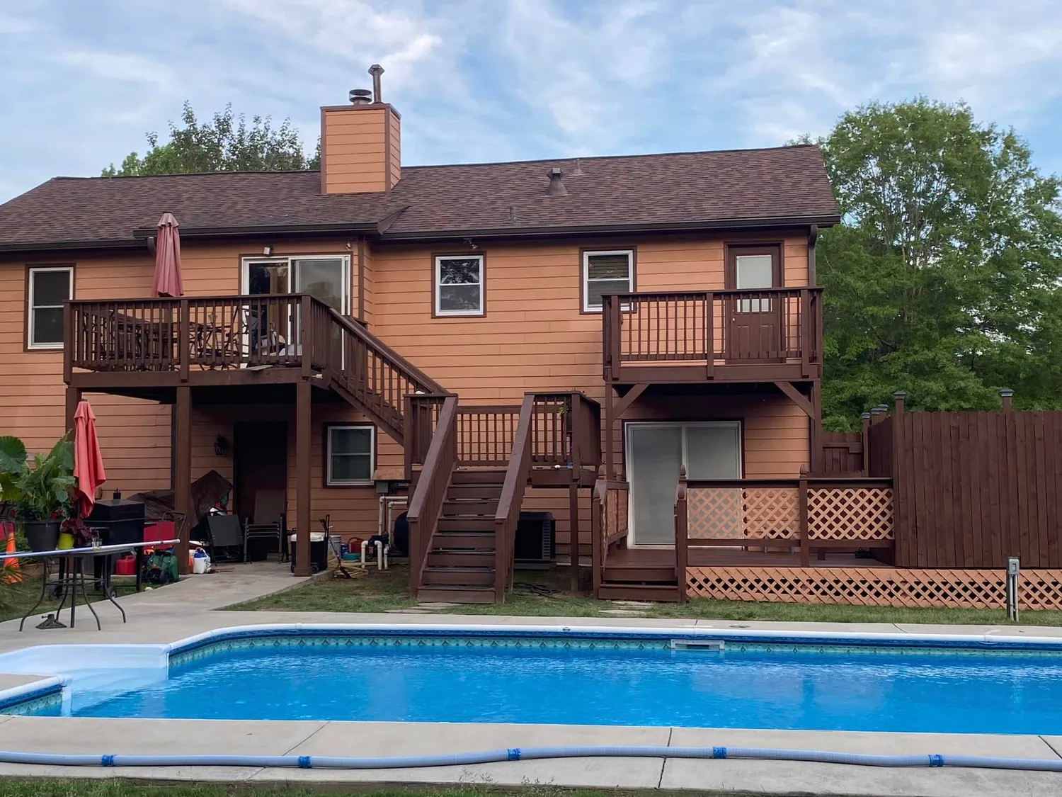 A house with a large swimming pool in front of it