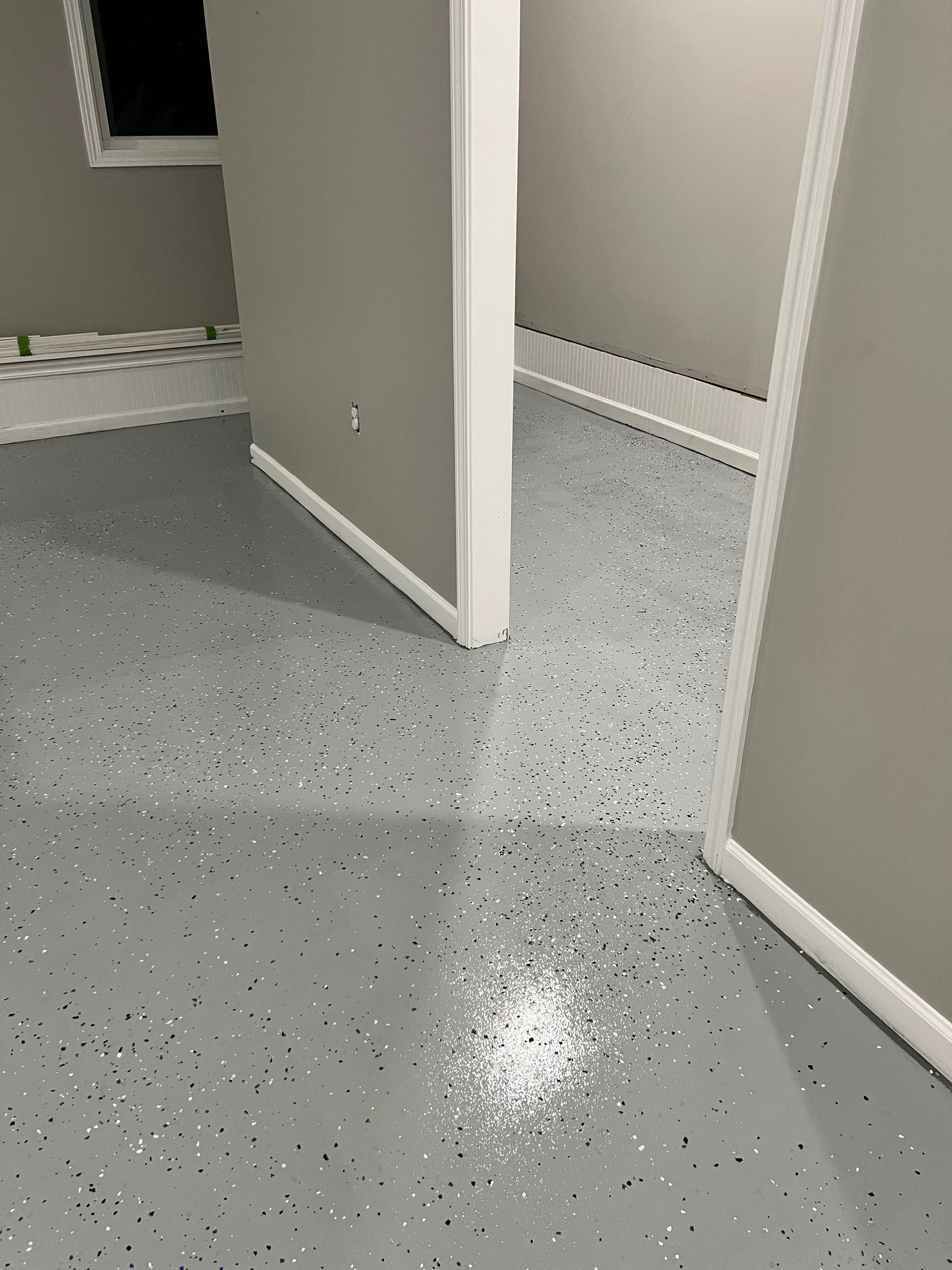 A room with a gray floor and white walls.