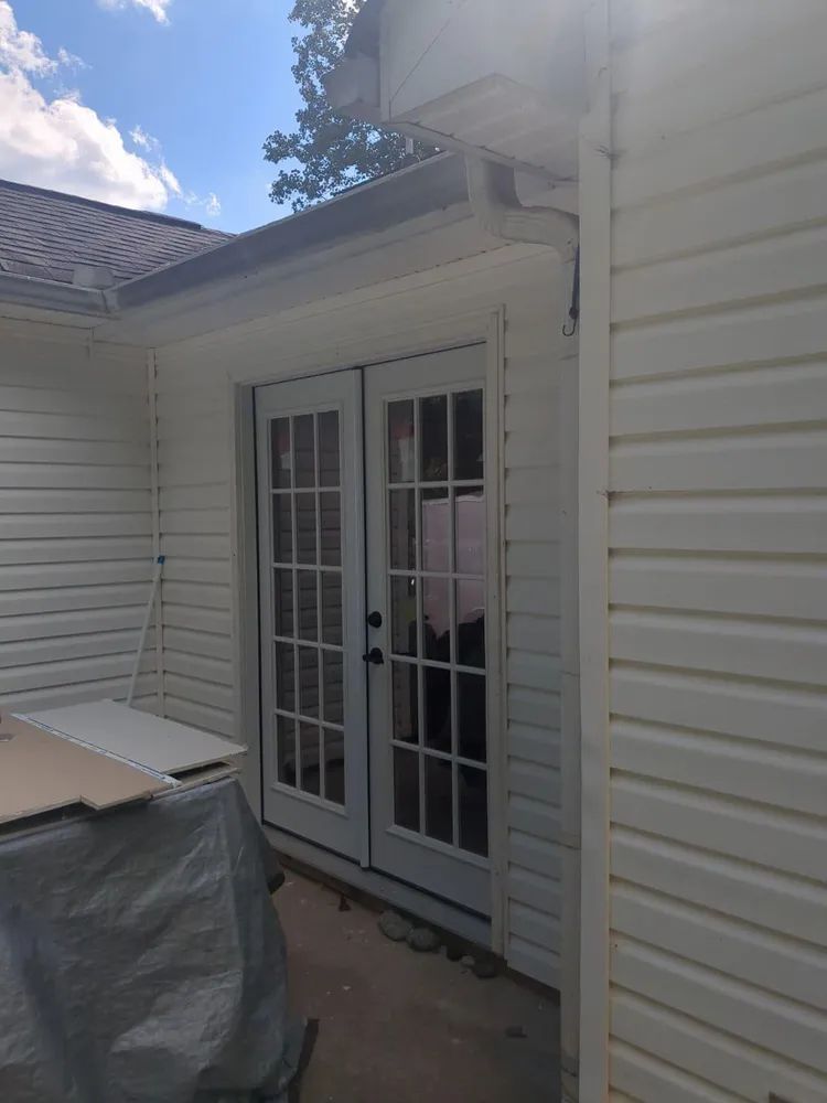 A white house with a sliding glass door