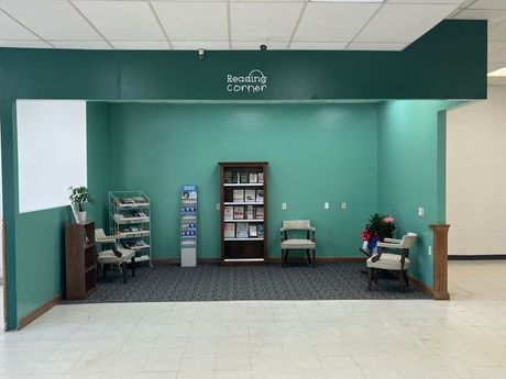 A room with green walls and a sign that says reading center