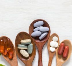 There are many different types of pills in wooden spoons.