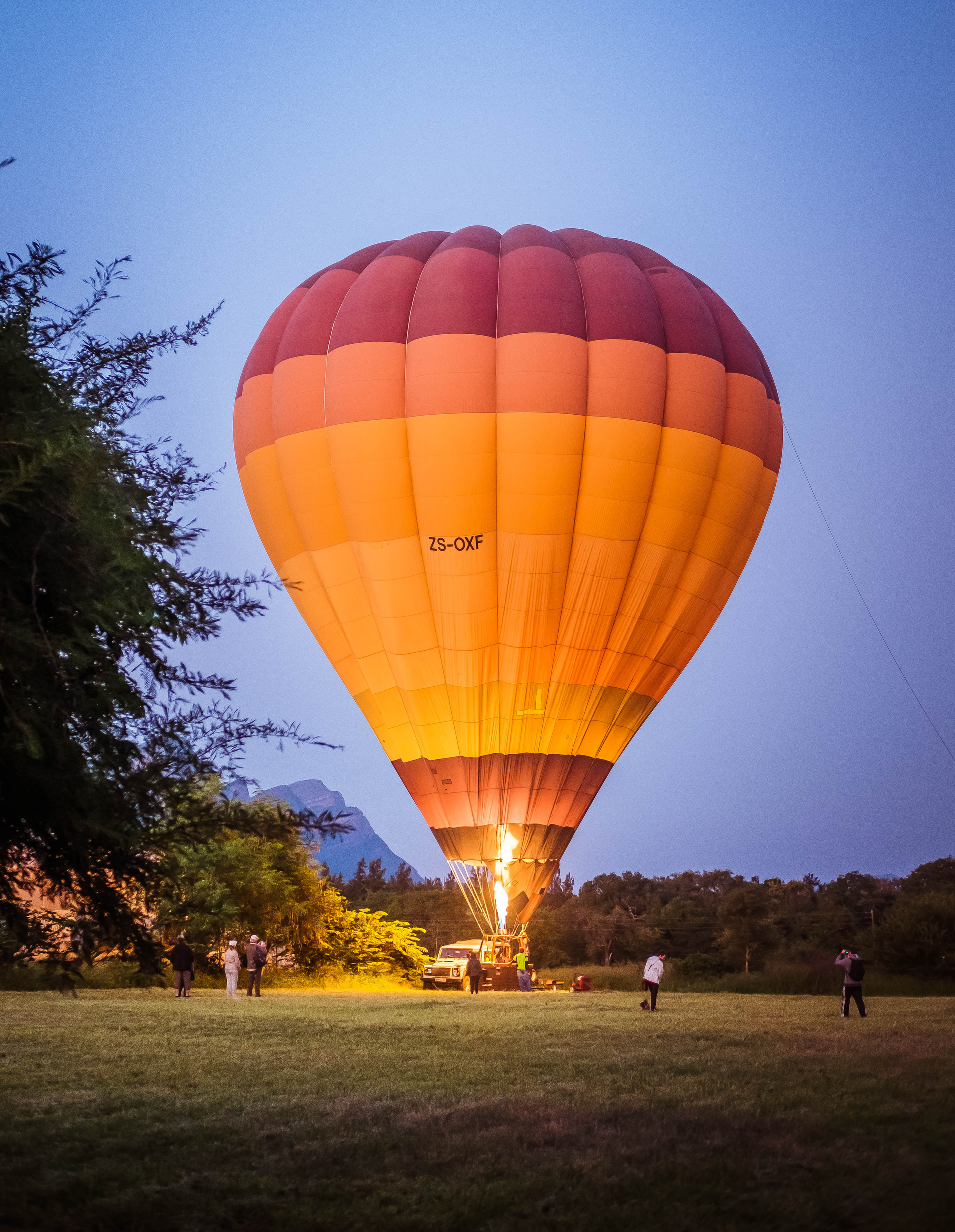 A hot air balloon is being loaded with people