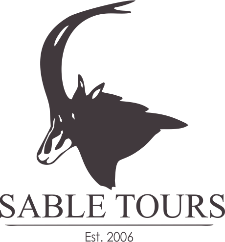 A black and white logo for sable tours