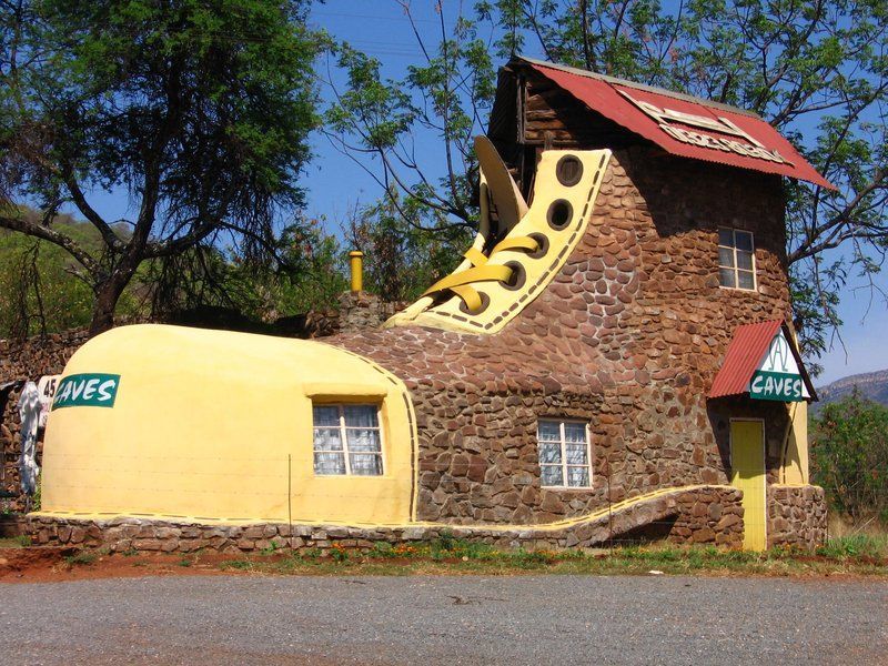 A building that looks like a shoe has a sign that says caves