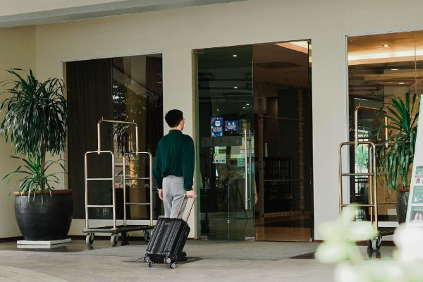 A man is pulling a suitcase into a Hotel in Cabanatuan Nueva Ecija