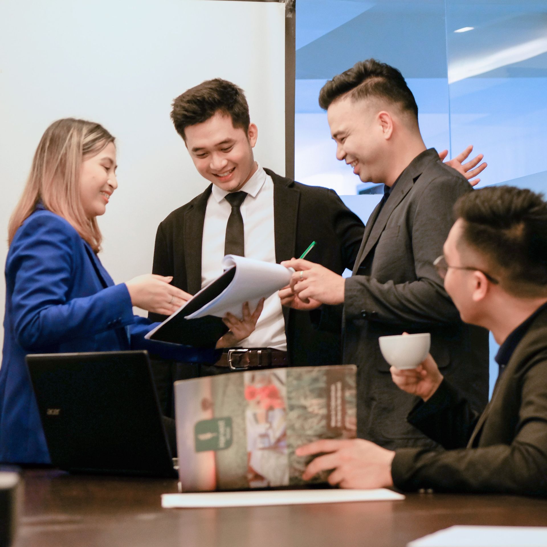 A group of professionals in a successful meeting, showcasing the productive environment and services at Harvest Hotel for business accommodation.