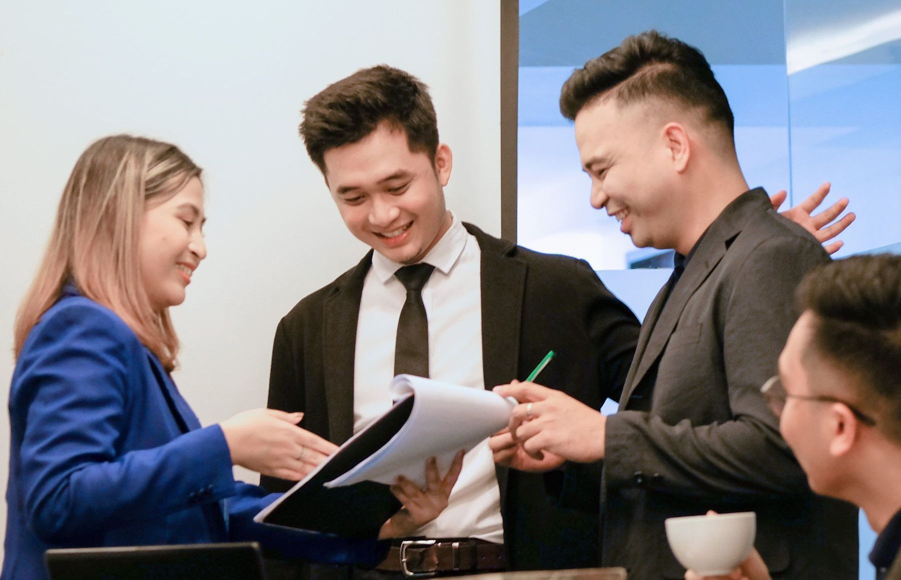 A group of business people are having a meeting in an office.