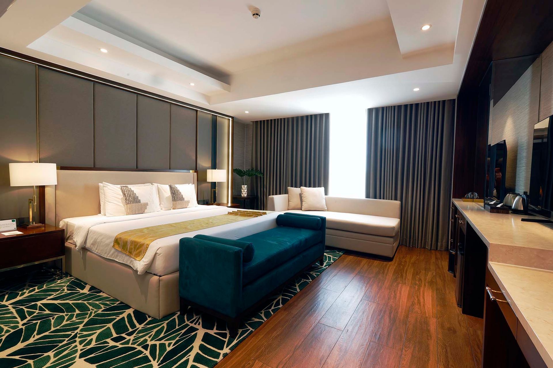 The luxurious Executive Suite at Harvest Hotel, featuring a separate seating area for the ultimate business accommodation.