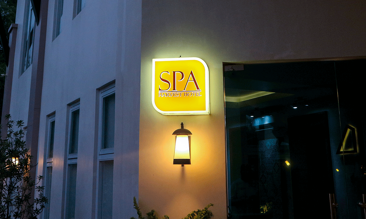 The illuminated sign for The Spa at Harvest, a wellness facility offering relaxing treatments to guests of this premier hotel in Cabanatuan.