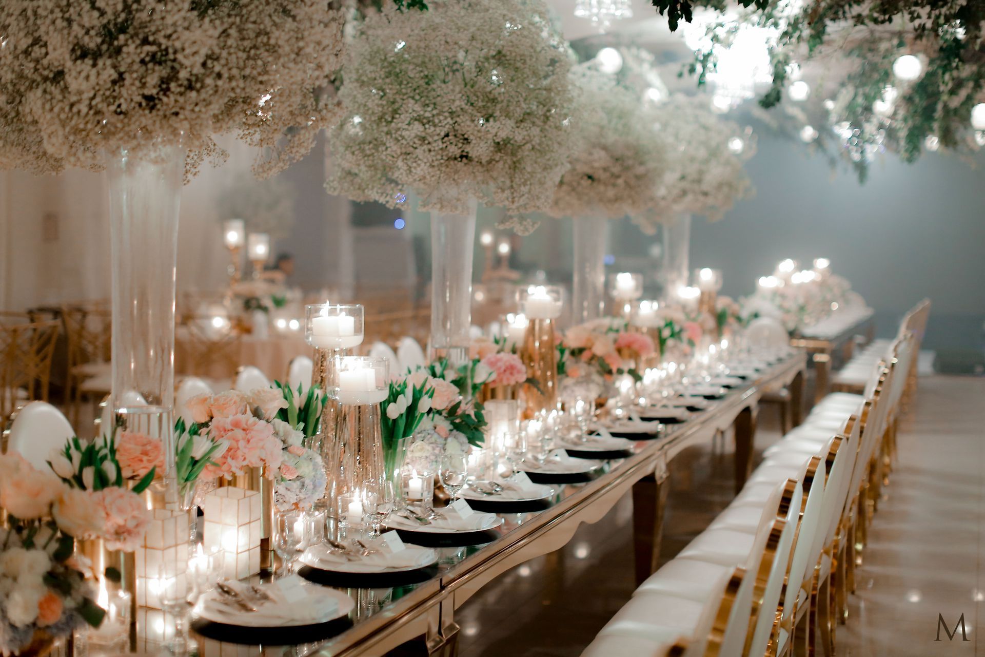 A long table with plates , candles , and flowers in an events place in cabanatuan