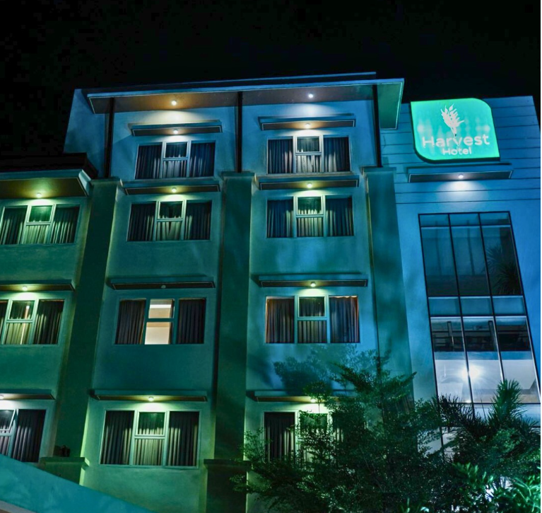 Harvest hotel lit up at night