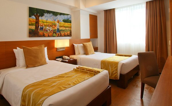 A comfortable guest room with two beds at Harvest Hotel, providing excellent business accommodation in Cabanatuan.