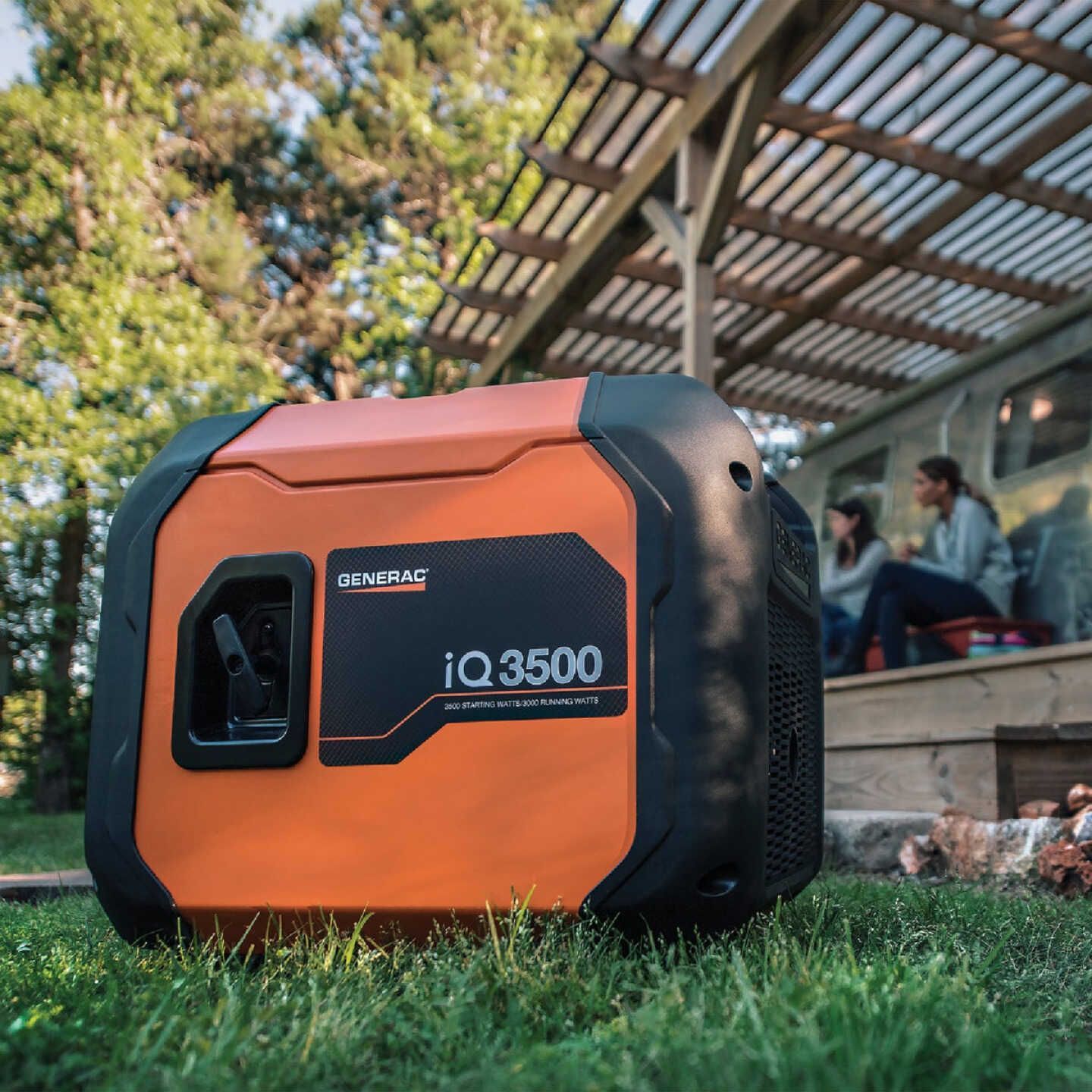 a generator is sitting on the side of a house in the rain .