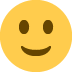 Smiling yellow face with brown eyes.