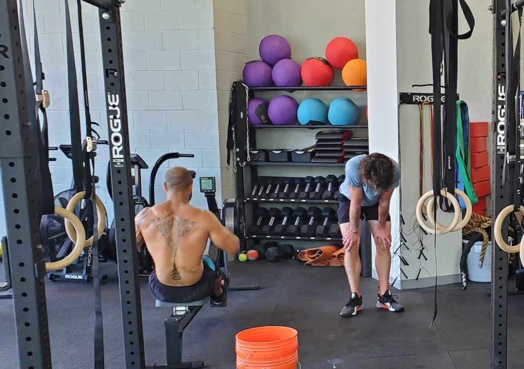 Members performing a high intensity rowing workout