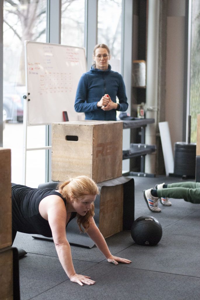 Member planking during partner workout