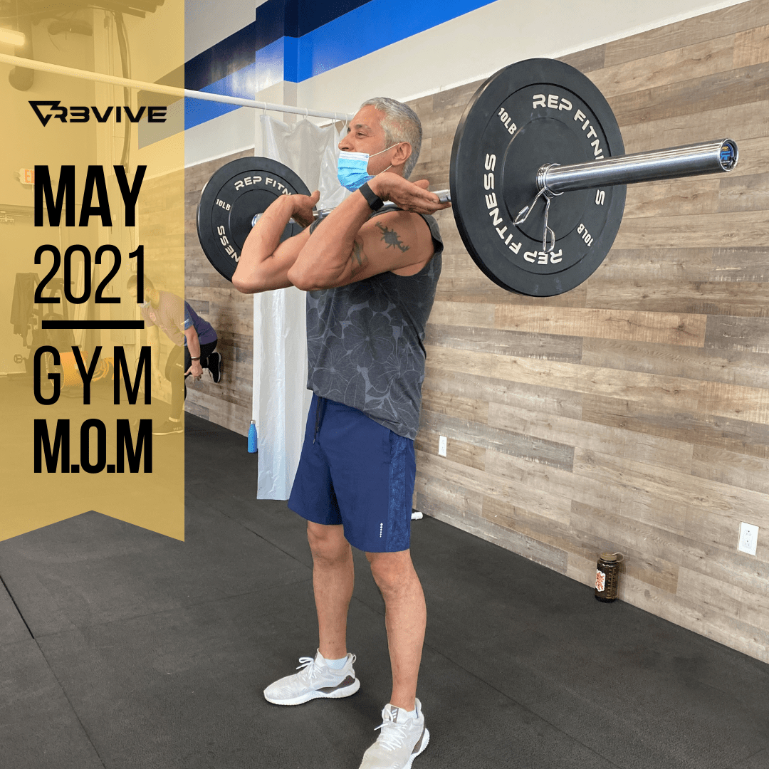Man lifting barbell at gym, wearing face mask and athletic wear. May 2021 Gym M.O.M. graphic.