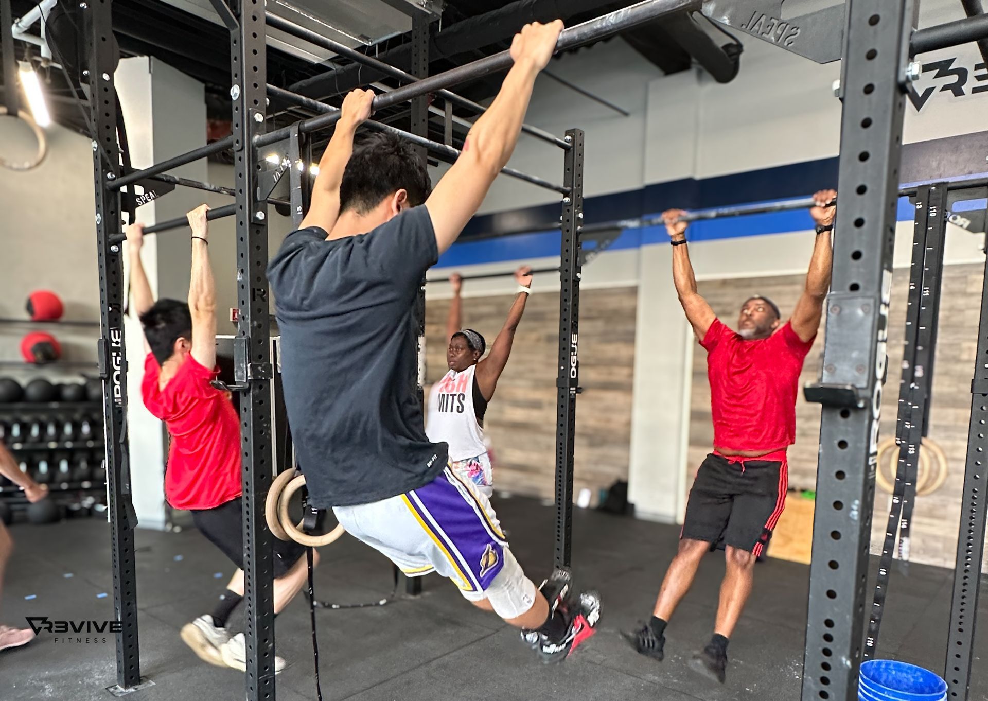 Members working on pull ups during functional fitness class.