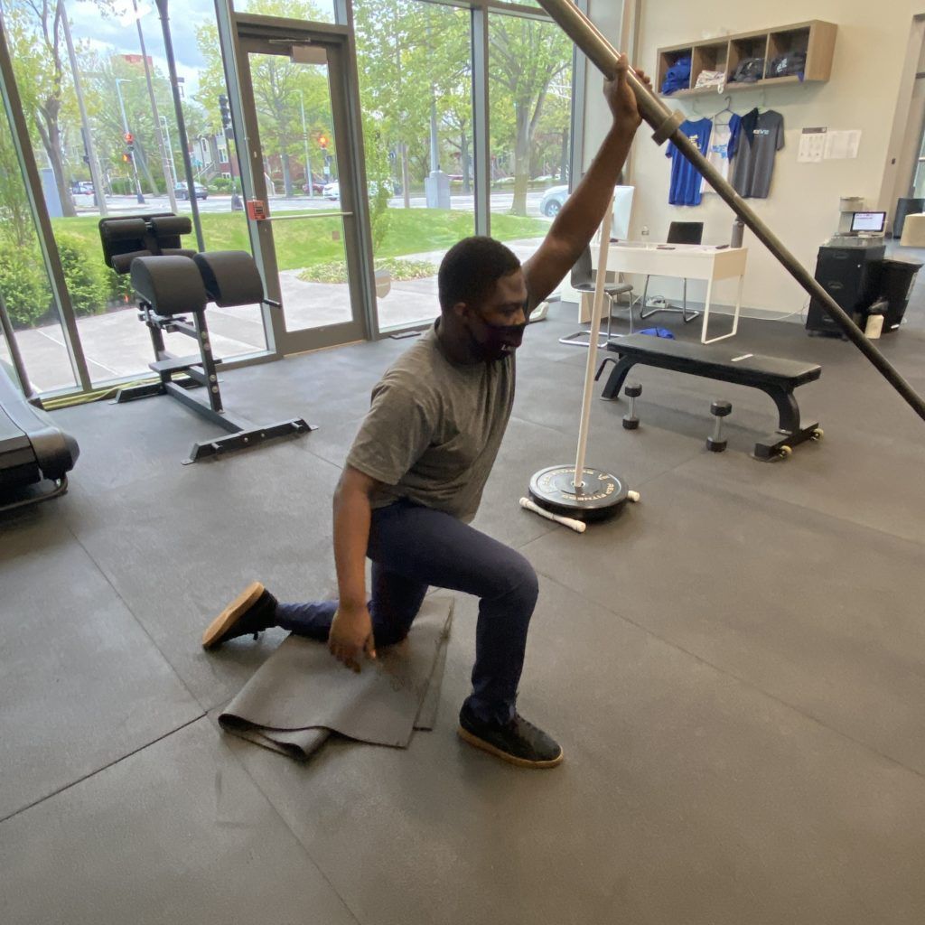 An athlete performing landmine presses