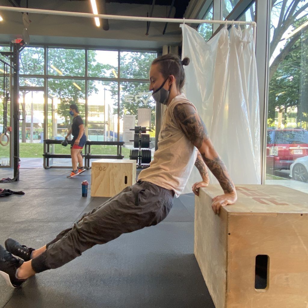 Athlete performing box dips