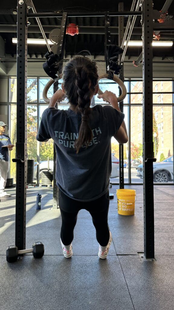 A member performing ring rows.