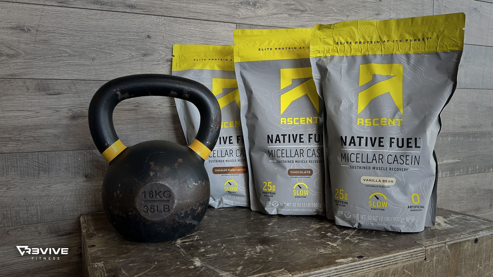 Kettlebell next to three bags of Native Fuel supplement on a gray surface. Bags are gray and yellow.
