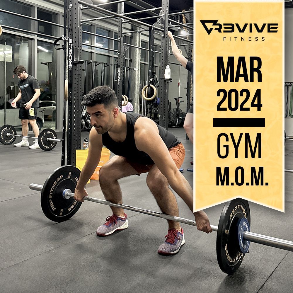 Man lifting barbell in gym; Revive Fitness