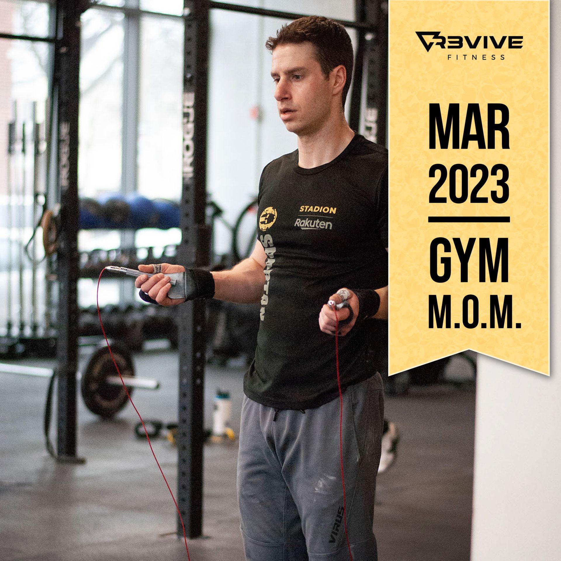 Man holding a jump rope at a gym. He wears a black shirt and gray pants. Text reads
