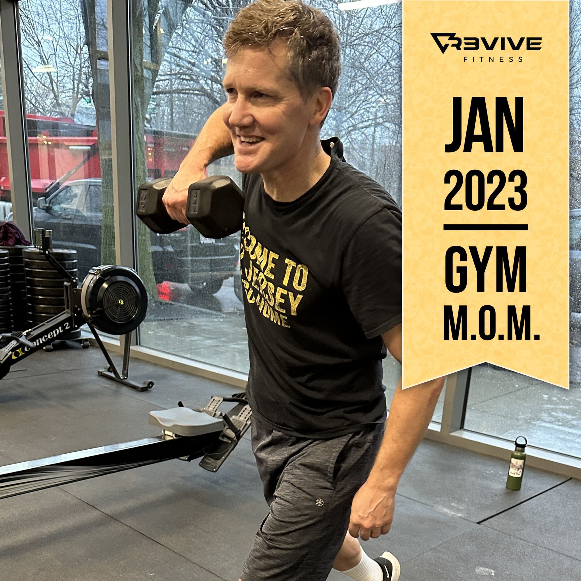 Man working out in a gym, holding a dumbbell, Jan 2023 Gym Mom.