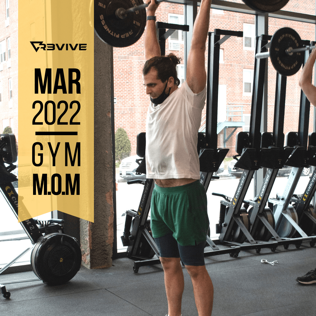 Man lifting weights in gym, wearing green shorts and white shirt. Text reads