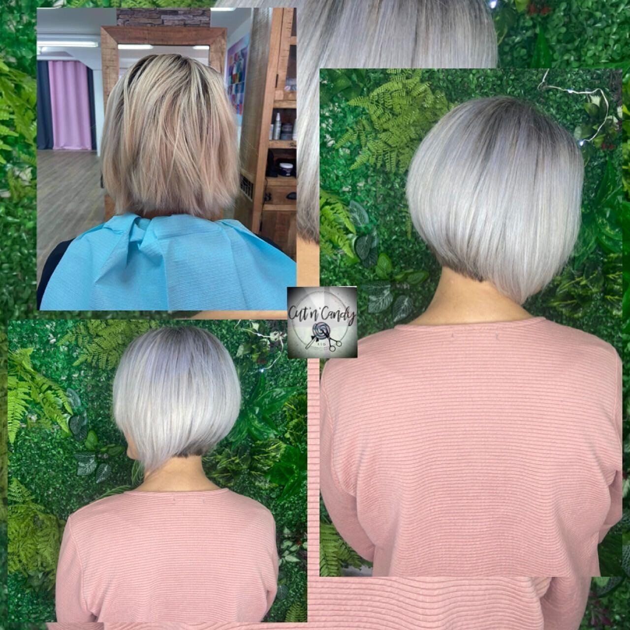 Eine Frau mit grauem Haar trägt ein rosa Hemd.