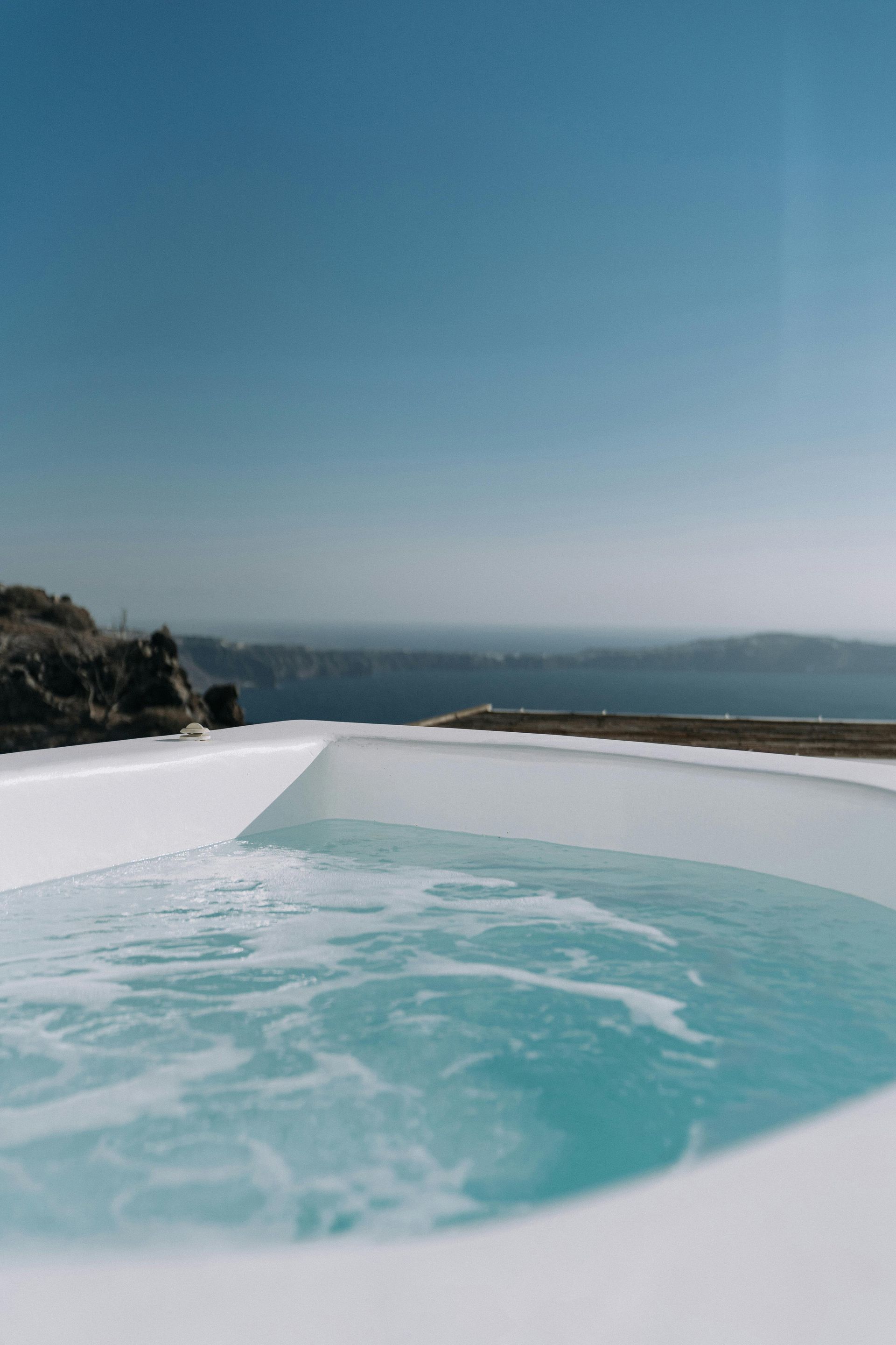 Stainless steel railings elegantly frame the pristine pool, creating a modern and sophisticated contrast.